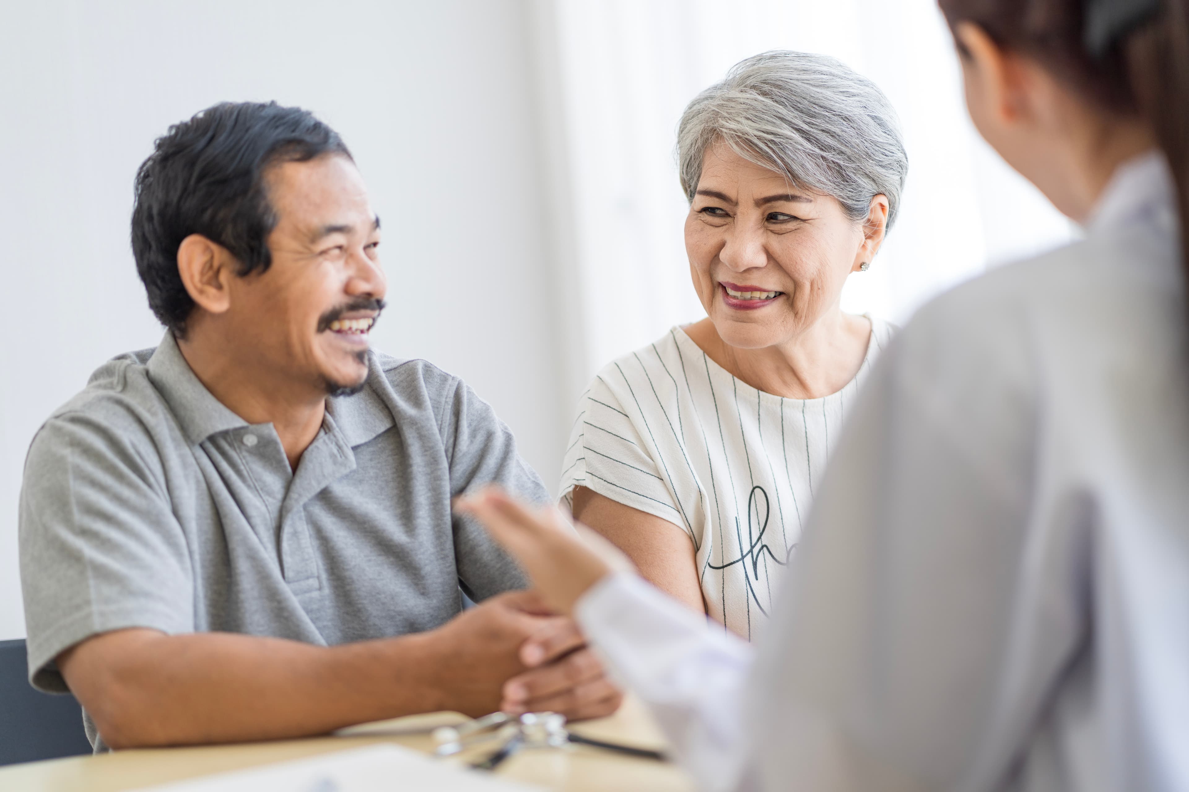 Elderly couple sits with Financial Advisor